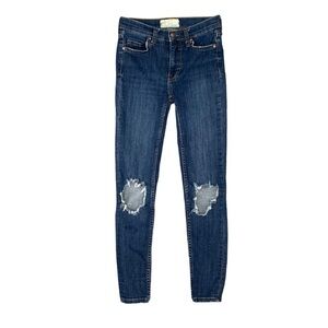 Free People Busted Knee high-rise skinny jeans in a dark wash.